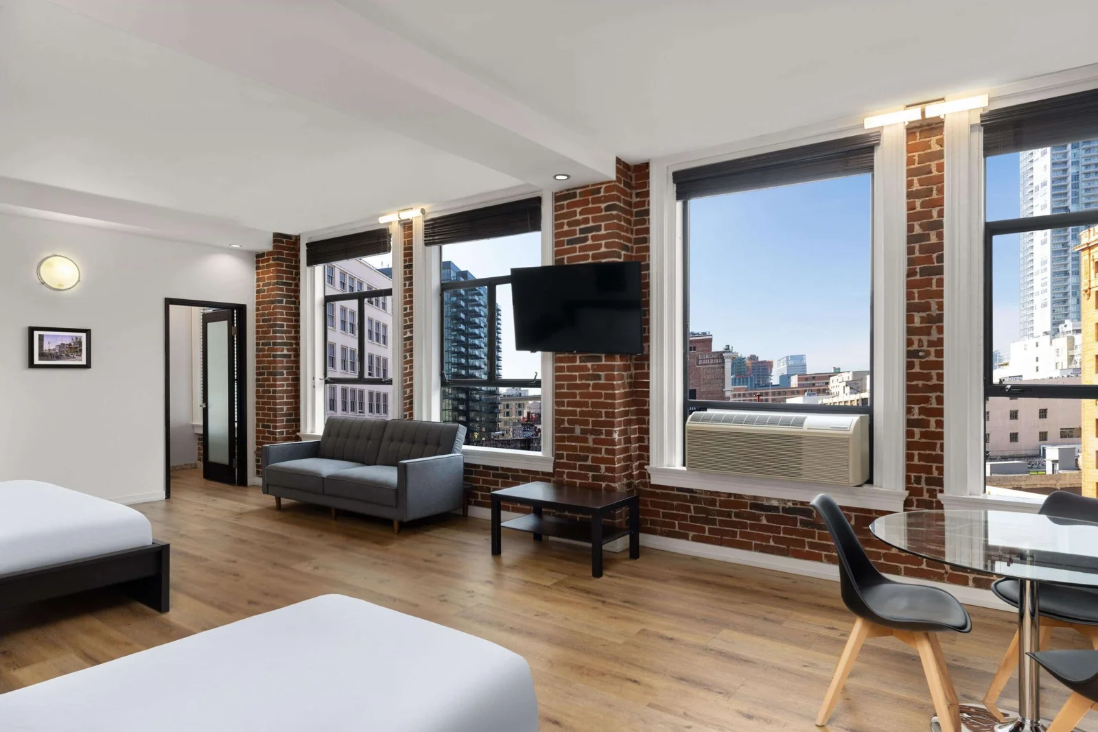 Apartment living area with large windows at The Haas